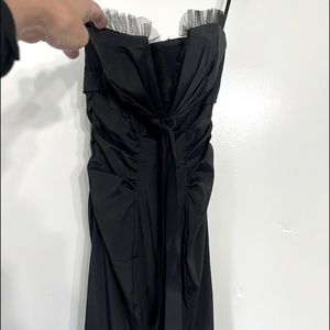 Black evening dress knee length , form fitting and elegant.   Padded bra cups.